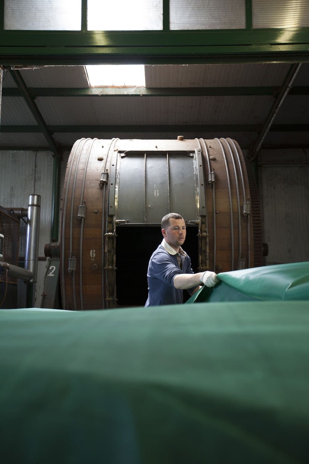 Workshop inspection beside a leather production floor.