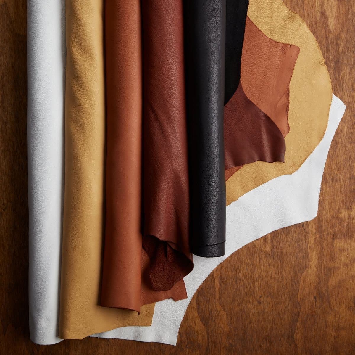 Leather swatches laid out across a studio table.